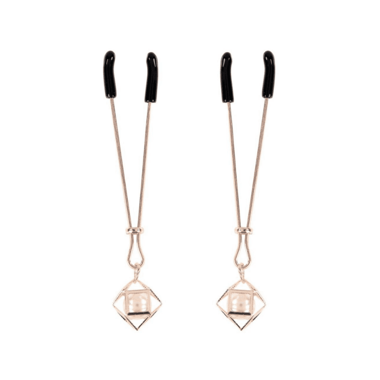 a set of yellow gold and pearl nipple clamps against a white background