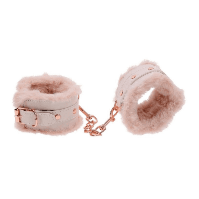 pink and rose gold furry handcuffs against a white background